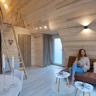 Wohnraum des Chalets Iorik mit Empore Heller Wohnraum des A-Frame-Chalets Iorik mit Empore unter dem Holzdachstuhl, bei Gérardmer